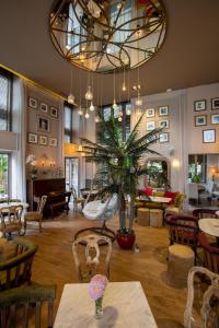 a restaurant with tables and chairs and a large chandelier at Marpessa Hotel & Spa in Agrinion