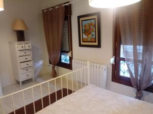 a bedroom with a staircase and a dresser and a window at Casa Marinera "Tu casa de Baiona" in Baiona