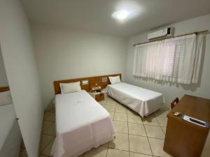 Postel nebo postele na pokoji v ubytování Ônix Hotel