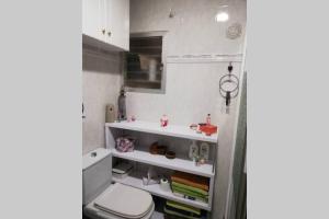 a bathroom with a toilet and a sink at Casa con terraza/Confortable house with terrace in Aigues