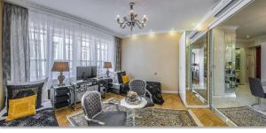 a living room filled with furniture and a chandelier at Center Residence 3 bedroom 3 bathroom in Budapest