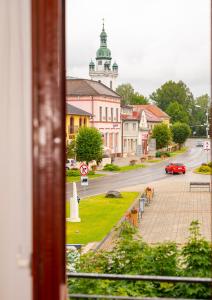 a view from a window of a street with a building at 2- posteľová izba s kúpeľňou EMKA v PENZION TRSTENÁ in Trstená