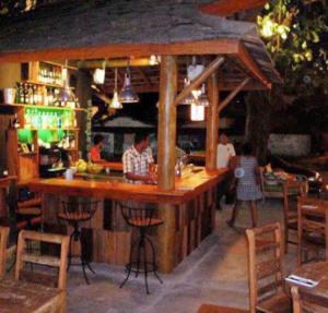 eine Bar in einem Restaurant mit Leuten, die dort sitzen in der Unterkunft Taibá Beach Resort casa térrea ou chalet enteiro in Taíba