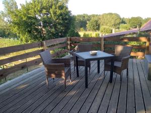 a table and chairs on a wooden deck at Ferienwohnung auf dem Land Mecklenburgische Seenplatte Müritz, ländliche Region in Below