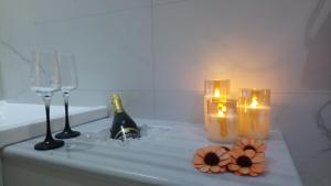 a bath tub with candles and wine glasses and flowers at Rhodes Demetrius Luxury Private Villa in Kalathos