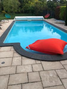 マルコルスハイムにあるAlsace Maison 5p piscine Europapark Rulanticaの赤い枕の真ん中にあるスイミングプール