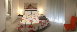 a bedroom with a large bed with flowers on it at Casa Dell'Artista 2 in Salerno