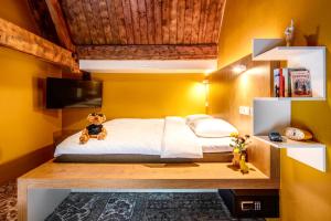 a bedroom with a bed with a teddy bear sitting on it at Bunk Hotel Amsterdam in Amsterdam