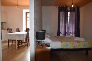a bedroom with a bed and a table and a dining room at Agritur Michelotti Giancarlo in Arco