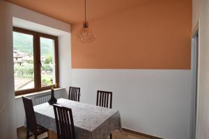 a dining room with a table and chairs and a window at Agritur Michelotti Giancarlo in Arco