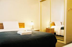 a hotel room with two beds and a mirror at Little Tokyo Hotel in Los Angeles