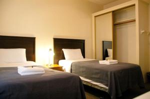 a hotel room with two beds and a mirror at Little Tokyo Hotel in Los Angeles