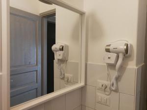 a mirror in a bathroom with a hair dryer at Le luminarie in Mottola