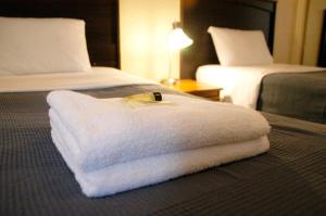 a white towel on a bed in a hotel room at Little Tokyo Hotel in Los Angeles
