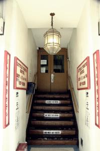 a lobby with a staircase with a door and a light at Little Tokyo Hotel in Los Angeles
