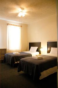 a room with two beds and a window at Little Tokyo Hotel in Los Angeles
