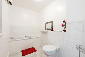 a white bathroom with a toilet and a sink at 2 Bed Flat, Dedicated workspace, Parking, 4KTV in London