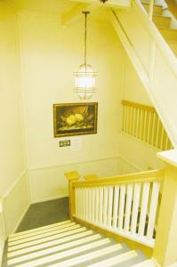 a hallway with a staircase with a chandelier at Little Tokyo Hotel in Los Angeles