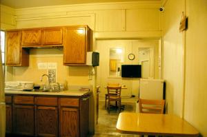 a kitchen with wooden cabinets and a table and chairs at Little Tokyo Hotel in Los Angeles