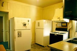 a kitchen with two white refrigerators and a stove at Little Tokyo Hotel in Los Angeles