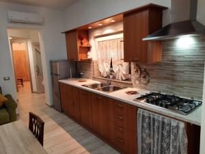 a kitchen with a sink and a stove top oven at GUEST HOME in Casamicciola Terme +8 photos