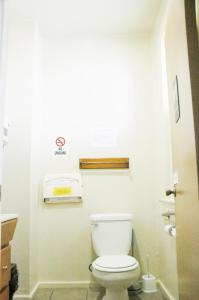 a bathroom with a white toilet in a room at Little Tokyo Hotel in Los Angeles