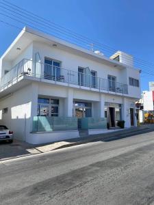a white building on the side of a street at ElleNapa Apts & Studios in Ayia Napa