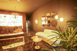 HOTEL CAVALTA في ميديلين: غرفة معيشة مع أريكة ونافذة