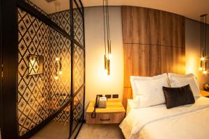 a bedroom with a bed and a phone on a table at Cavalta by Bernalo Hotels in Medellín