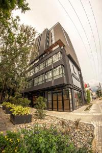 a large building with a lot of windows at Cavalta by Bernalo Hotels in Medellín +52 photos