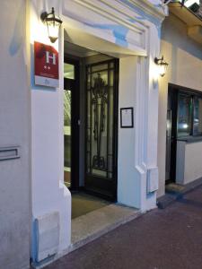 una entrada a un edificio con una puerta negra en Hotel Victor Hugo, en Clamart