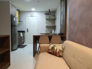 Aparthotel BSB Flats في برازيليا: غرفة معيشة مع أريكة ومطبخ