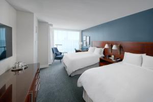 a hotel room with two beds and a chair at InterContinental San Francisco by IHG in San Francisco +138 photos