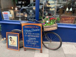 a bike parked in front of a bakery with signs at Sherlocks lodgings in Whitby
