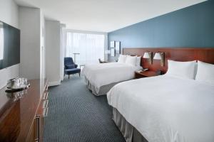a hotel room with two beds and a chair at InterContinental San Francisco by IHG in San Francisco