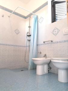 a bathroom with a toilet and a sink and a shower at villa Lina in Capilungo