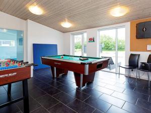 a billiard room with a pool table and a table at 14 person holiday home in V ggerl se in Marielyst