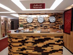 a hotel lobby with clocks on a wall at شقق درر رامه للشقق المخدومة 6 in Riyadh