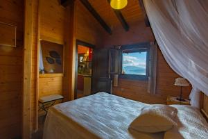 una camera da letto con un letto in una camera in legno con finestra di Apartamentos Cobres Rural a San Adrian de Cobres