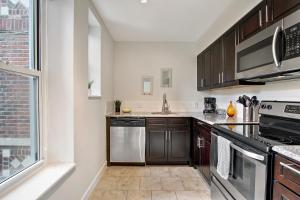 a kitchen with stainless steel appliances and a window at Vibrant Pad next to ForestPark/BJC/WashU in Maryland Heights