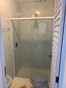 a bathroom with a glass shower with a toilet at Pousada Marques in Paraty +90 photos