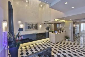 a large lobby with a hair salon with a checkered floor at Best Western Premier Milano Palace Hotel in Modena