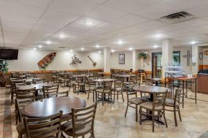 a dining room filled with tables and chairs at Comfort Inn & Suites Branson Meadows in Branson