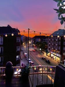 a view of a city street at sunset at Four Individual Beautiful Spacious Rooms In Stylish Apartment in Copenhagen