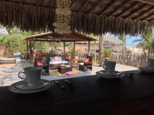 a table with two coffee cups on top of it at Pousada Portal do Kite in Tatajuba +41 photos
