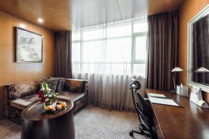 Habitación de hotel con escritorio y sofá en Holiday Inn Changzhou Wujin, an IHG Hotel en Changzhou