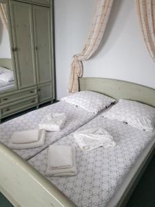 a bedroom with a bed with white towels on it at Apartament Zibi in Malbork