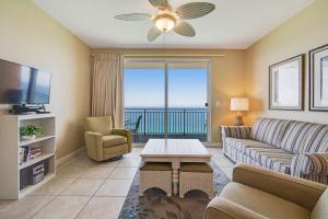 a living room with a couch and a tv at Splash Resort 1903W in Panama City Beach