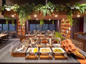 a buffet in a restaurant with food on display at Super Hotel Premier Kanazawaeki Higashiguchi in Kanazawa