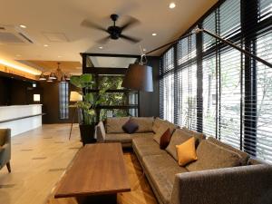 a living room with a couch and a table at The Celecton Kurume in Kurume